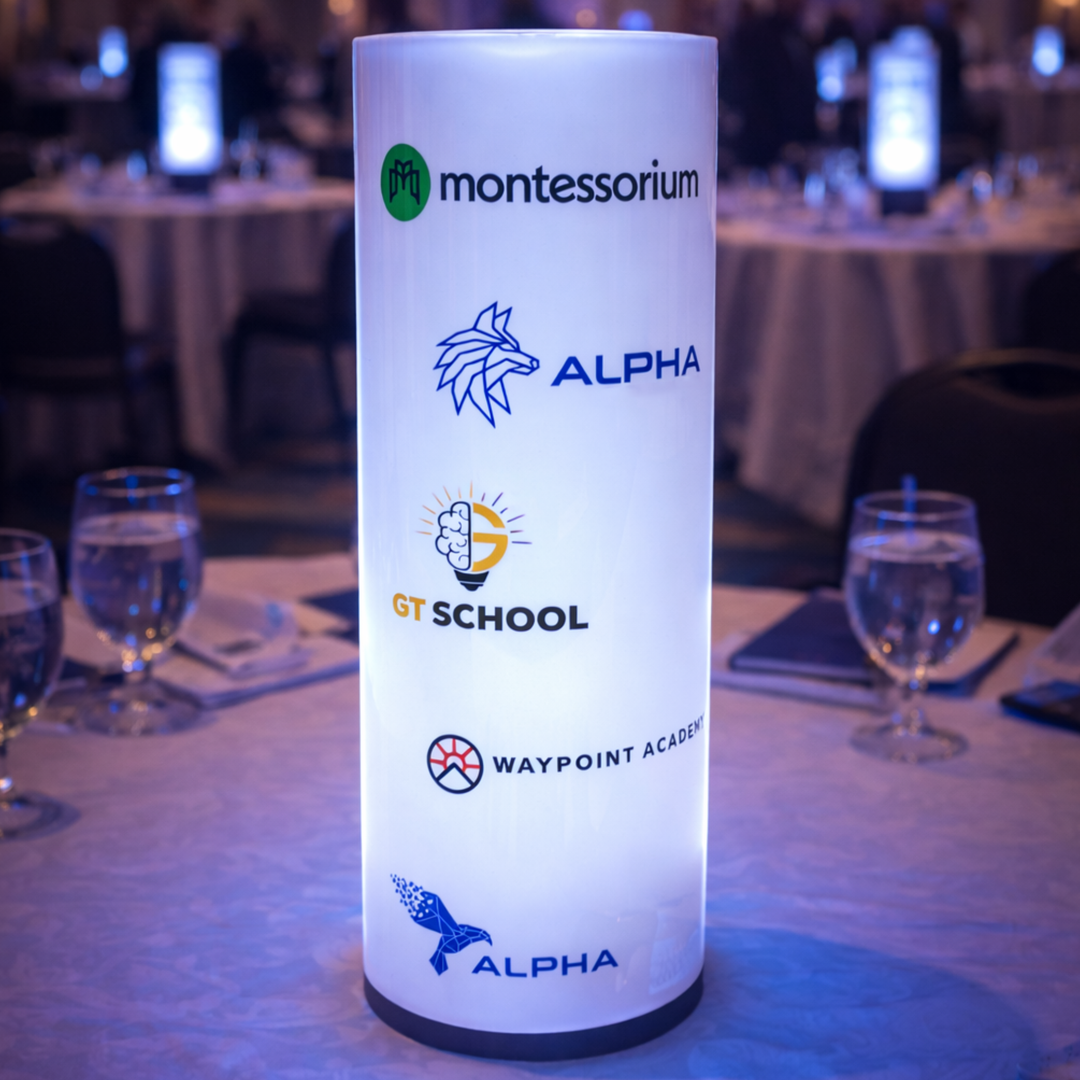  cylindrical light with logos on a table setting